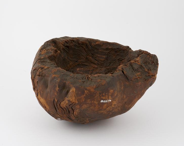 Roughly carved wooden bowl or mortar