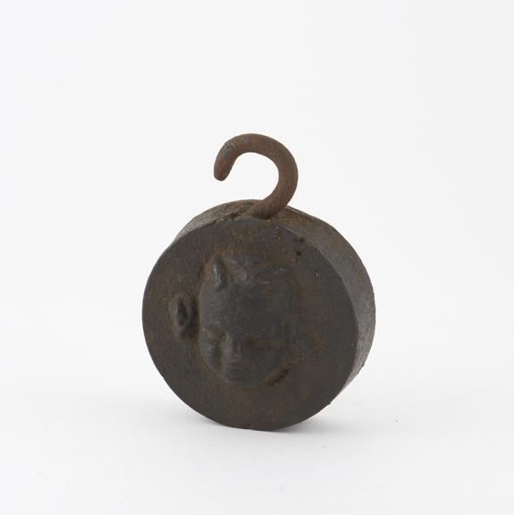 Circular cast bronze weight with hook for suspension (weights)