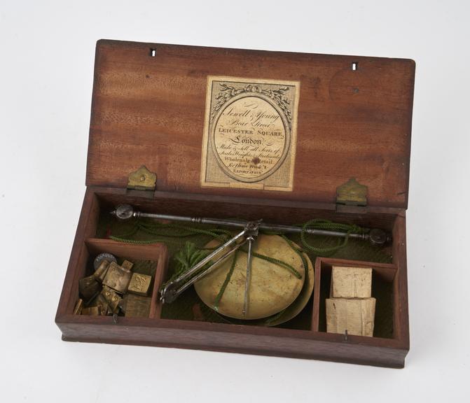 Apothecarys balance with steel beam and brass pans in wooden box