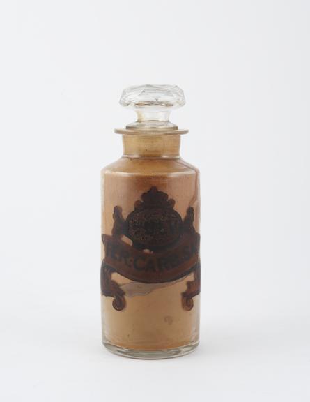 Bottle, clear glass, with contents