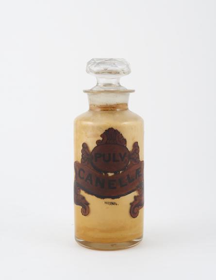 Bottle, clear glass, with contents, for powdered cinnamon