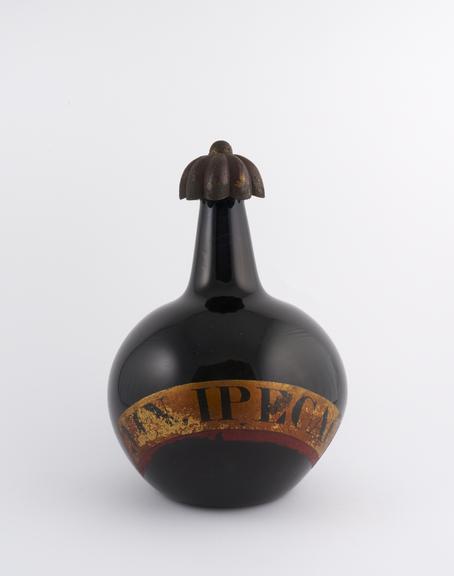 Carboy and metal cap, originally contained ipecacuanha wine