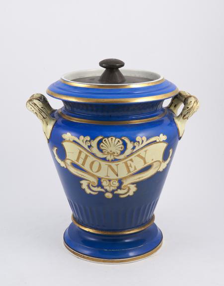 Blue drug jar decorated in yellow and gilt, with iron lid