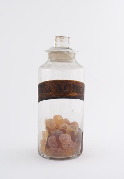 Bottle, clear glass, with content for gum acacia, English