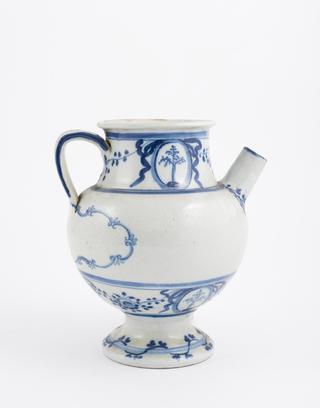 Blue and white syrup jar with dog and spoon on handle