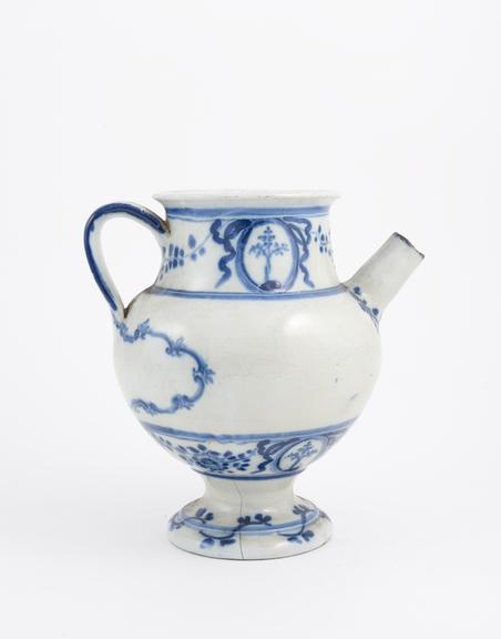 Blue and white syrup jar with dog and spoon on handle