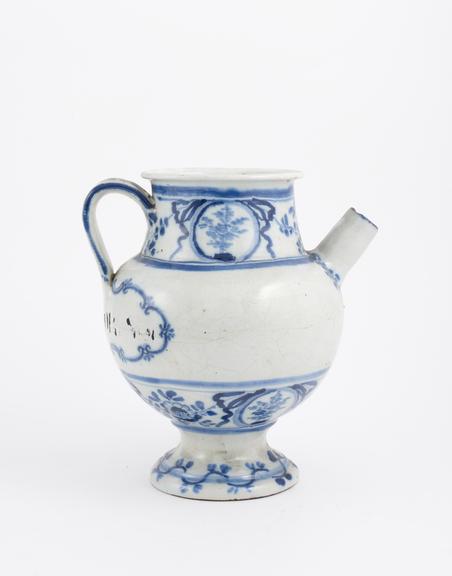 Blue and white syrup jar with dog and spoon on handle