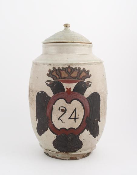 Tin-glazed earthenware drug jar, barrel-shaped, labelled