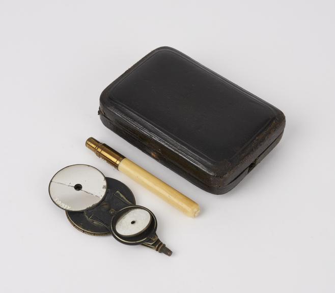 Ophthalmoscope with bare handle, in black leather-covered case