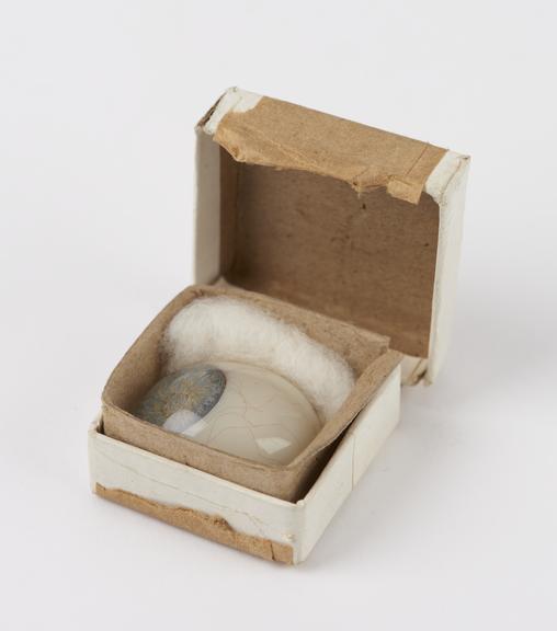 Glass artificial eye in cardboard box, possibly owned by Mr