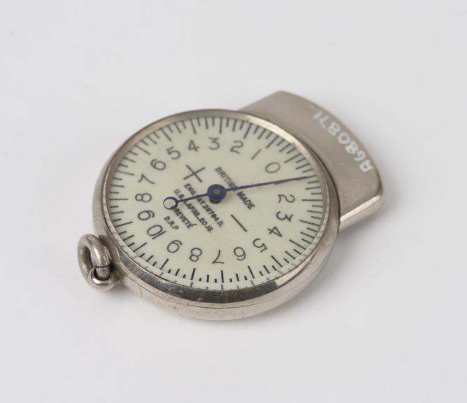 Steel plated optometer with cover over prong and suspension