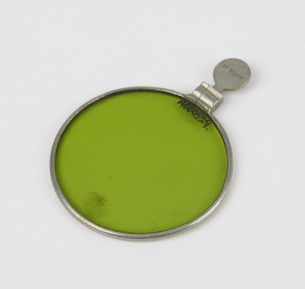 Green glass lens mounted in nickel-plated ring with handle