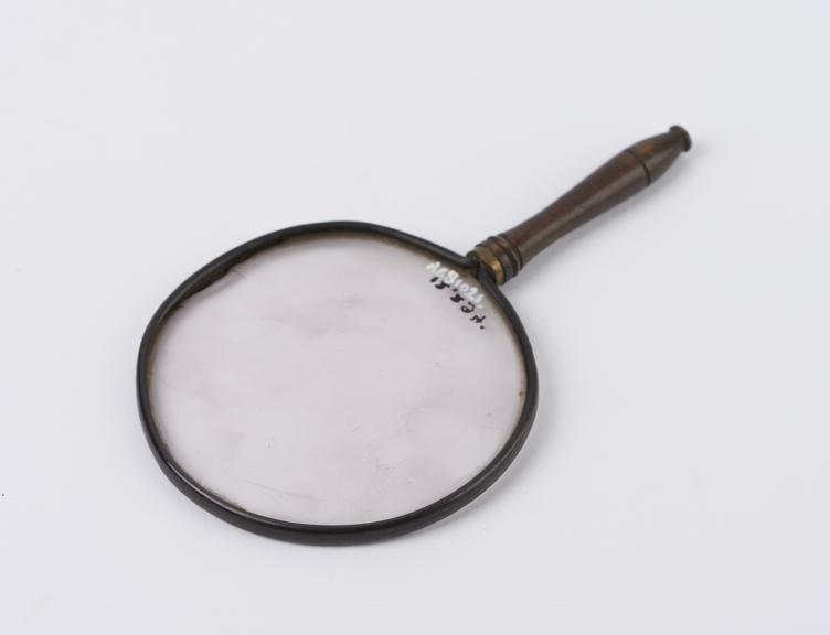 Magnifying glass with vulcanite rim and turned wooden handle