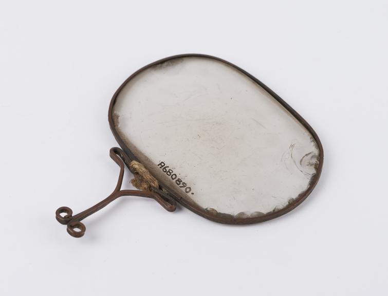 Magnifying glass, oval lens, set in copper wire frame