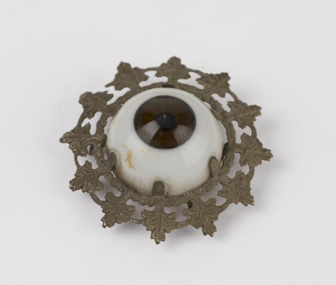 Glass eye, in metal frame