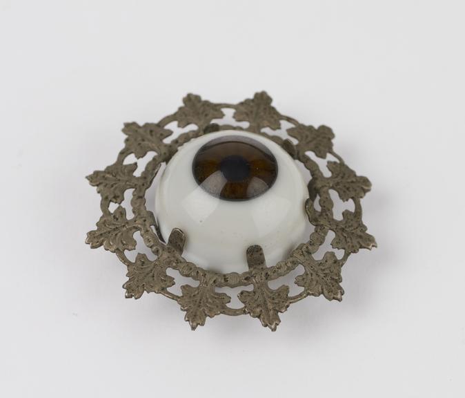 Glass eye, in metal frame