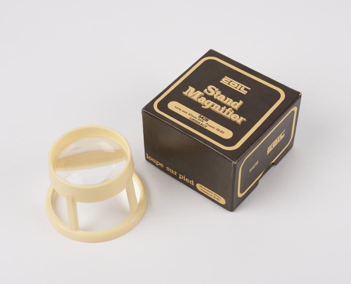 The Aspheric Magnifier, on plastic stand, in cardboard box