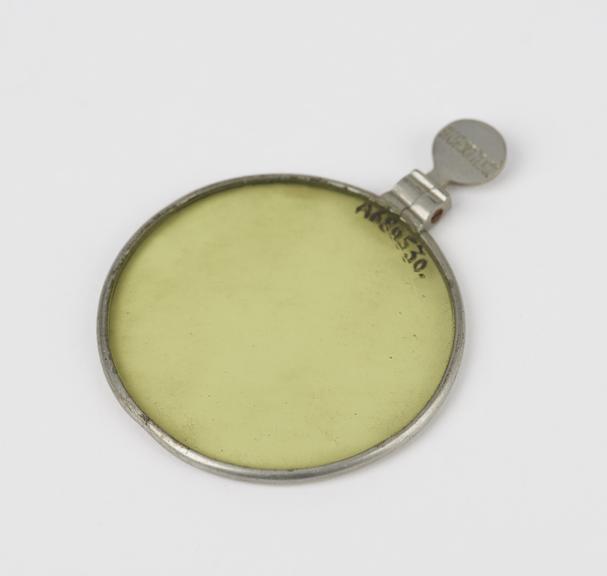 Light green glass lens mounted in nickel-plated ring with