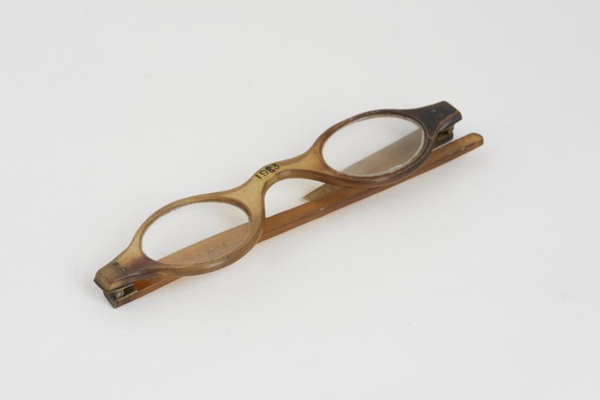 Spectacles, straight, horn, brass hinges, left arm broken