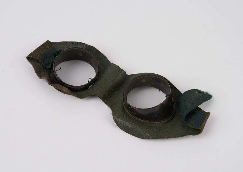 Metal rimmed protective spectacles in green leather mask