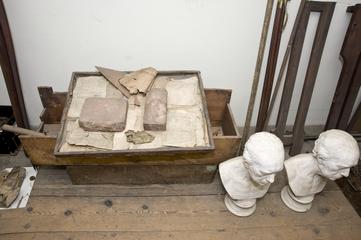 Box containing wood patterns and an iron casting