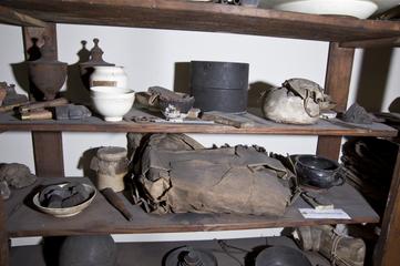 Brown jar, paper cover, label indistinct