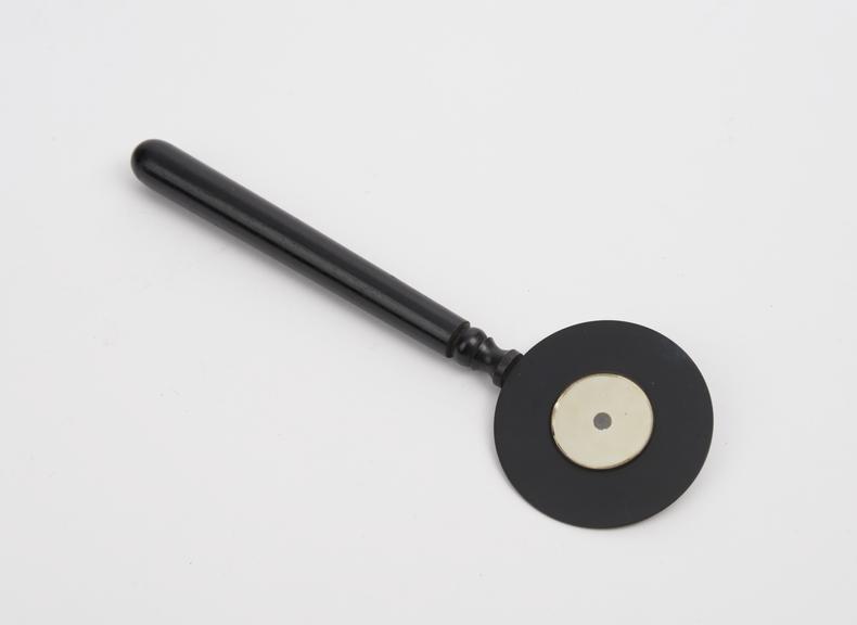 Retinoscope, mirror on brass disc with bakelite handle