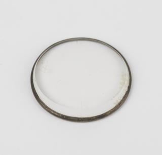 Brass-rimmed lens with graded bevelled edge
