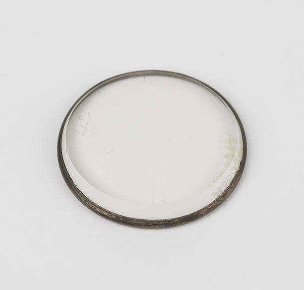Brass-rimmed lens with graded bevelled edge