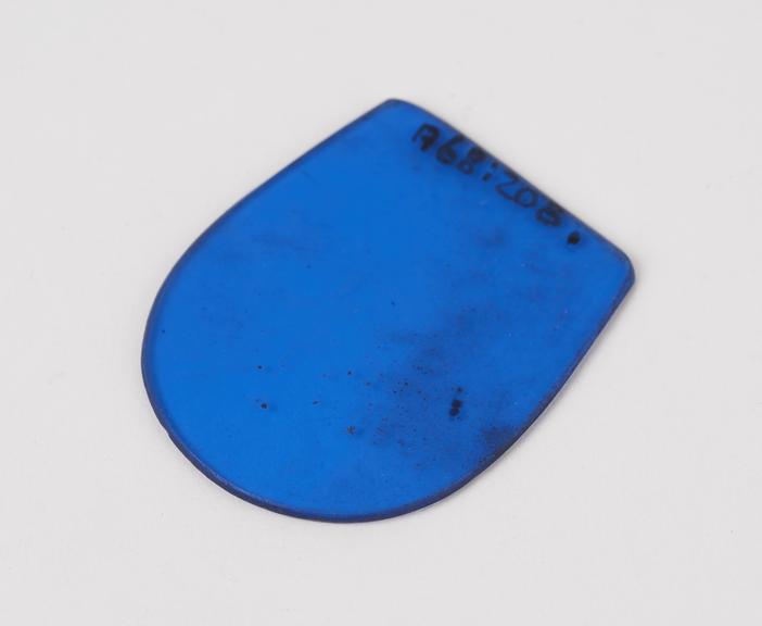 Lens, glass, thumb tip shaped, blue tinted, European, 1880-1950