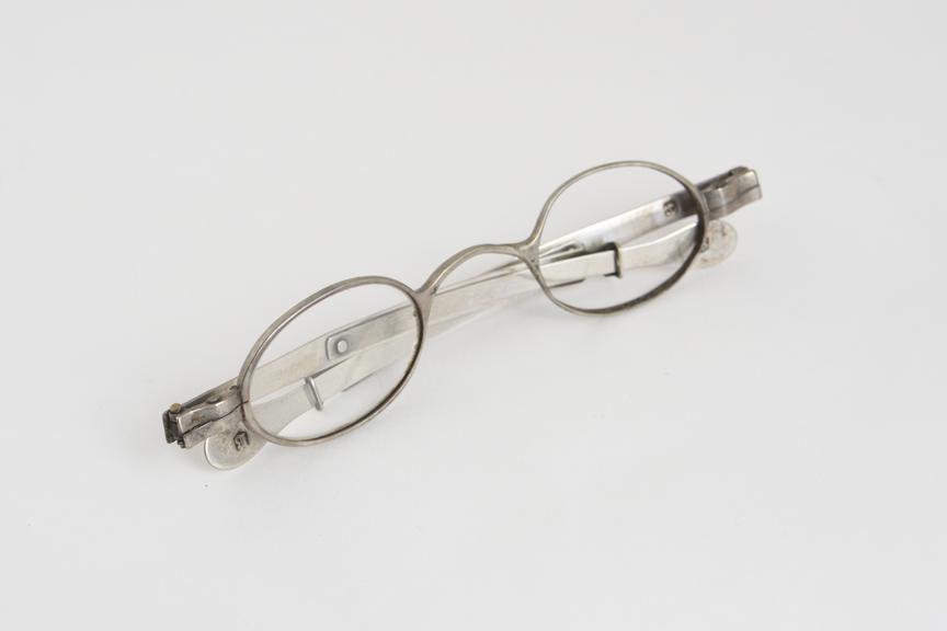 Extending spectacles, silver, left lens missing, marked T.M