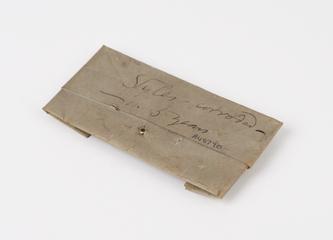 Two lachrymal styles wrapped in paper