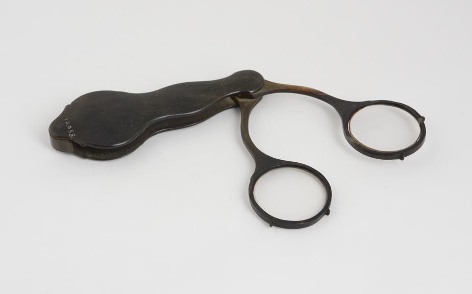 Scissor spectacles, hand and folding, all horn, said to be rare