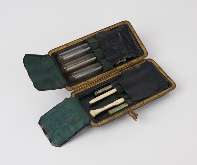 Set of surgical instruments in black leather brass-bound case