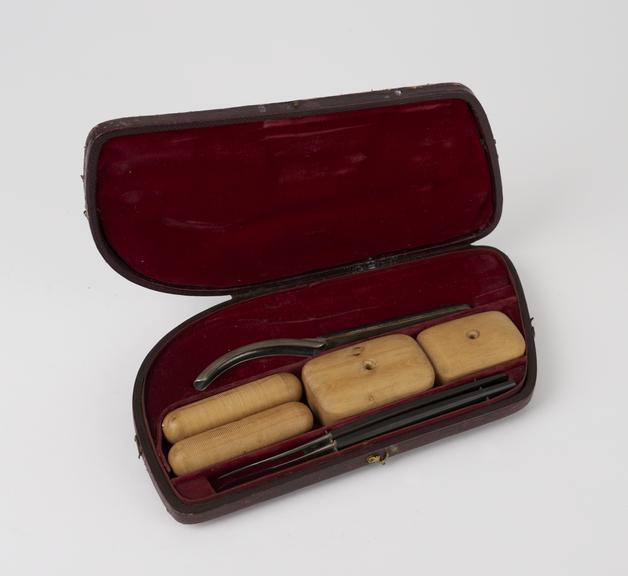 Unidentified objects in leather case, including 2 scalpels