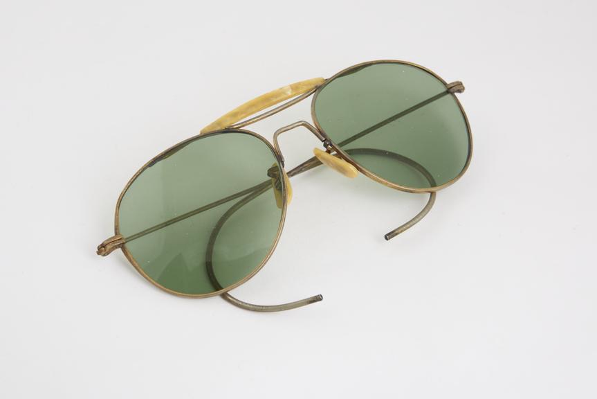 Pair of aviator sunglasses with green tinted lenses, no maker