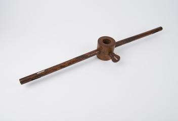 Circular boxwood clamp with a wooden rod set into each side