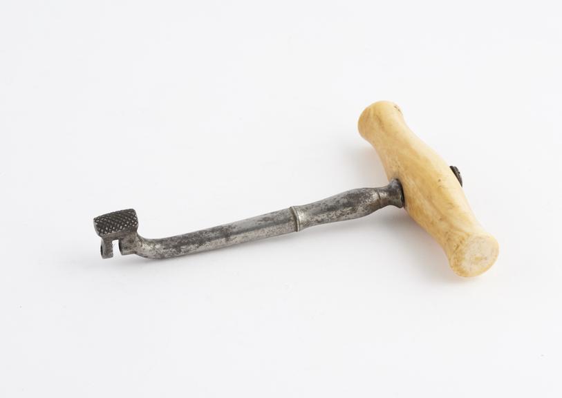 Dental key, slightly ornamented shaft, single bend