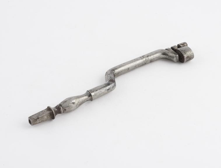 Dental key, clightly ornamented shaft with double bend