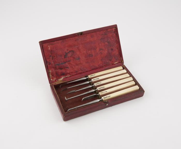 Dental descaler set in rectangular red leather covered case