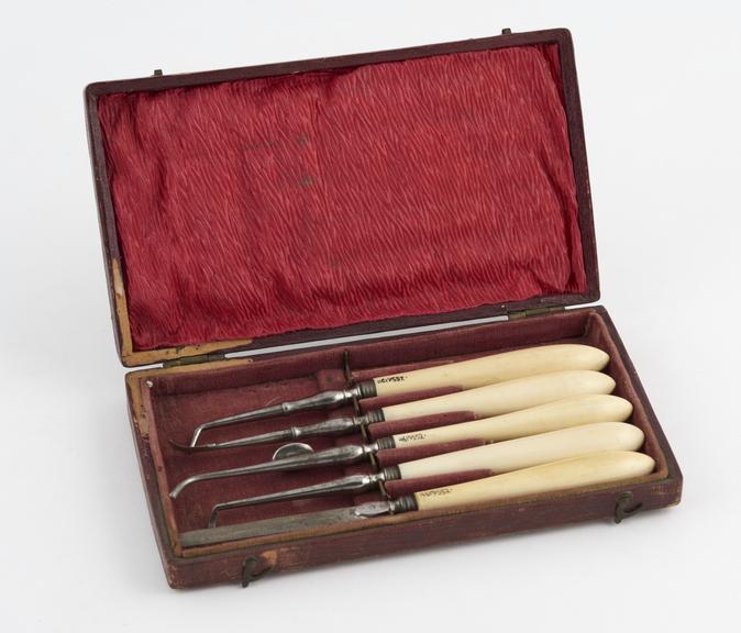 Dental instrument set, in rectangular red leather covered case