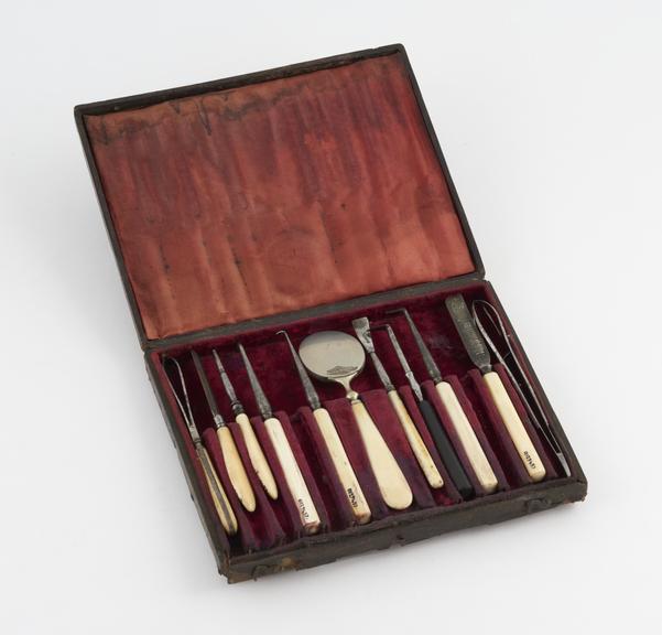 Dental instrument set, in tooled maroon leather covered case