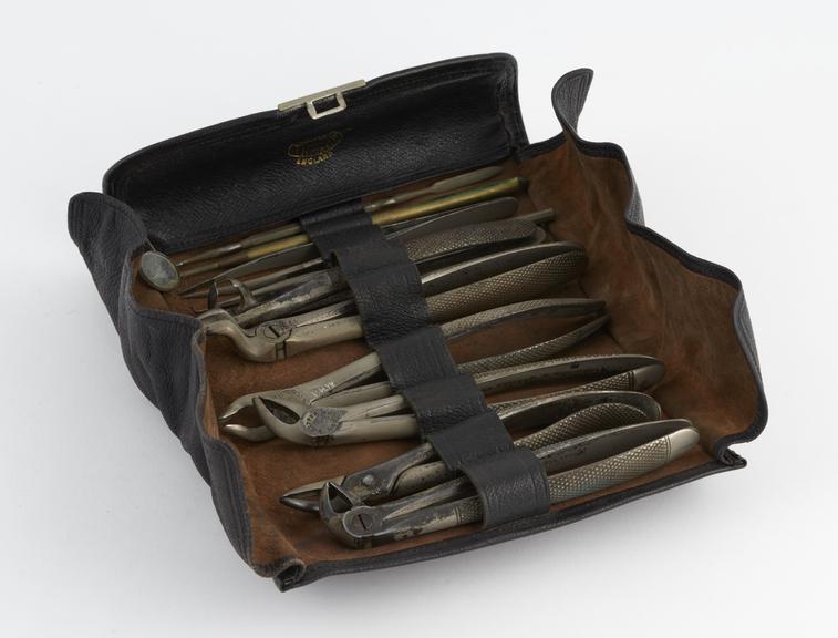 Dental instrument set, in leather rool, by C. Ash, Sons and Co