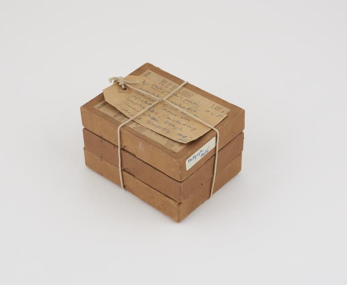 Four small brown cardboard boxes containing photographic