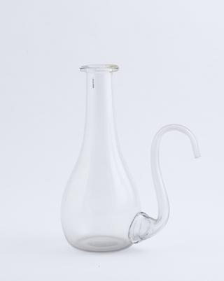 Clear glass jug with curving pouring spout at side
