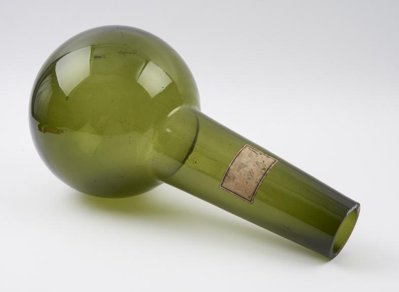 Dark green glass flask, spherical bulb, tubular neck