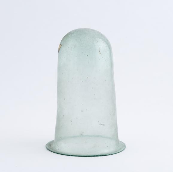 Pale green glass beaker with round base and flared rim