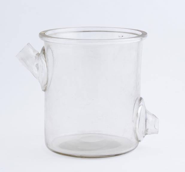 Clear glass jar, cylindrical, with two outlets at side