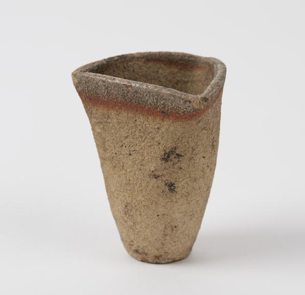 Unglazed earthenware crucible with circular base and triangular