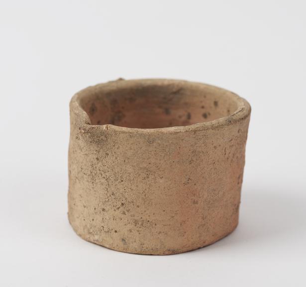 Flat-bottomed earthenware crucible with lip, handle broken